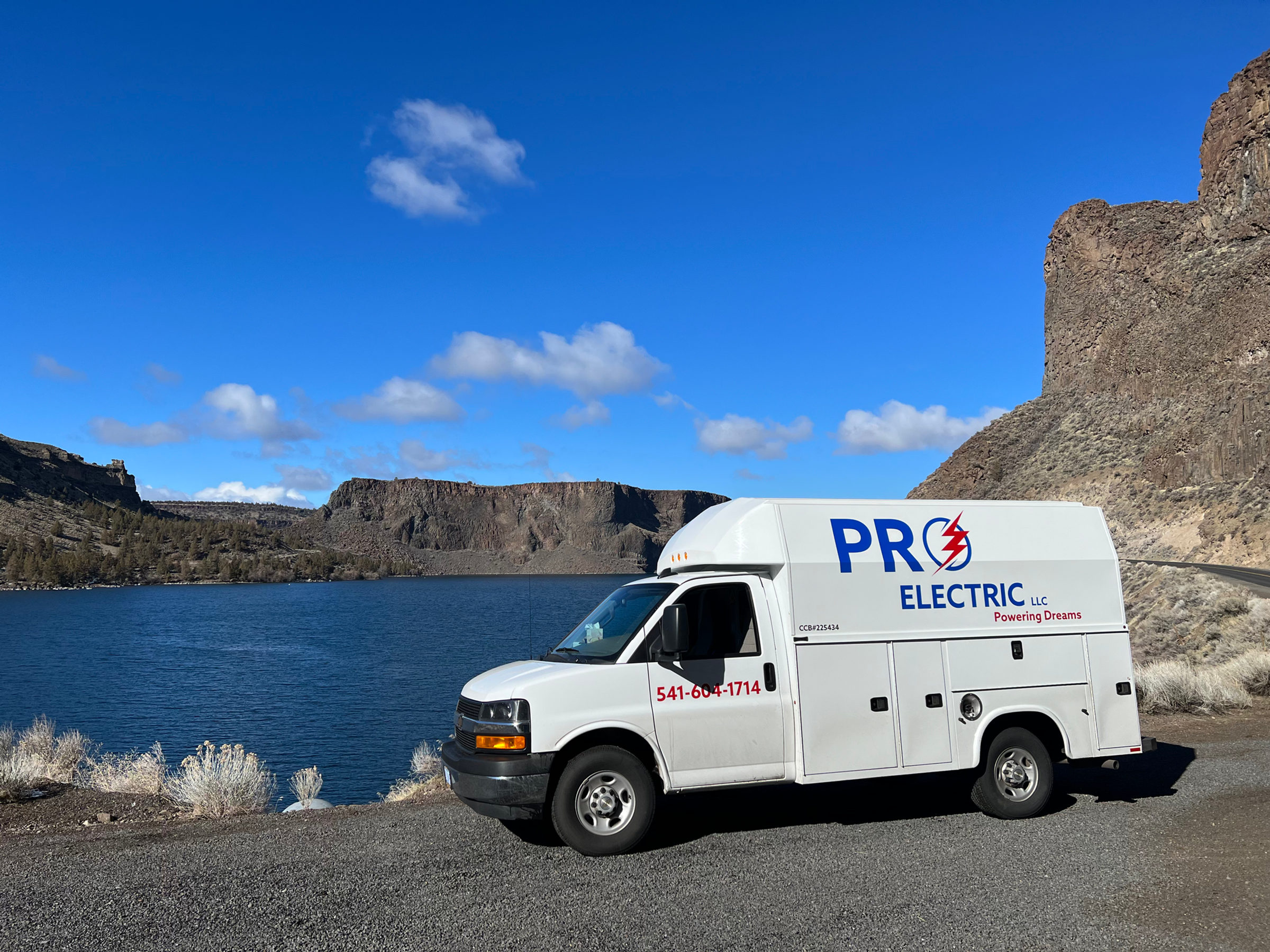 Pro Electric service van parked above Lake Billy Chinook beneath basalt rimrock